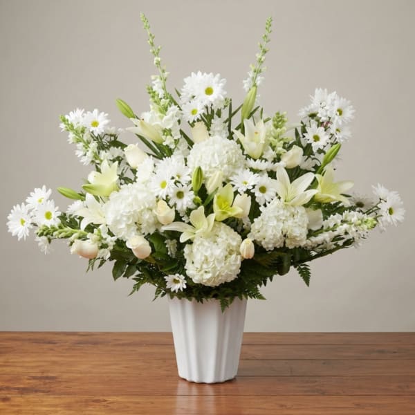 White floral arrangement in a tall white vase