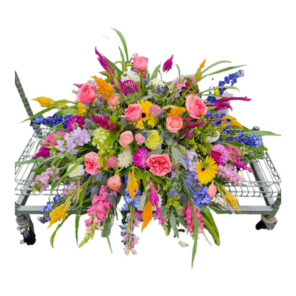 Large colorful floral spray on a metal cart