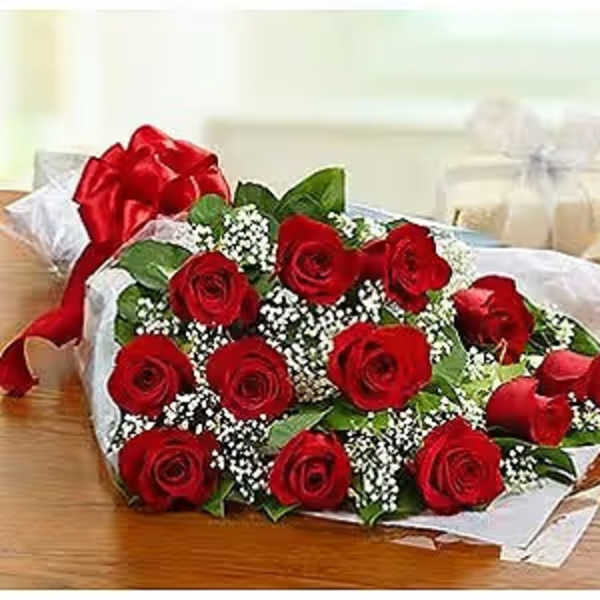 Bouquet of red roses with white filler flowers wrapped in paper