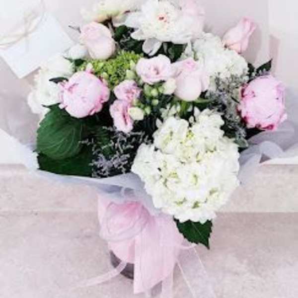 Pink and white bouquet with ribbon in a box