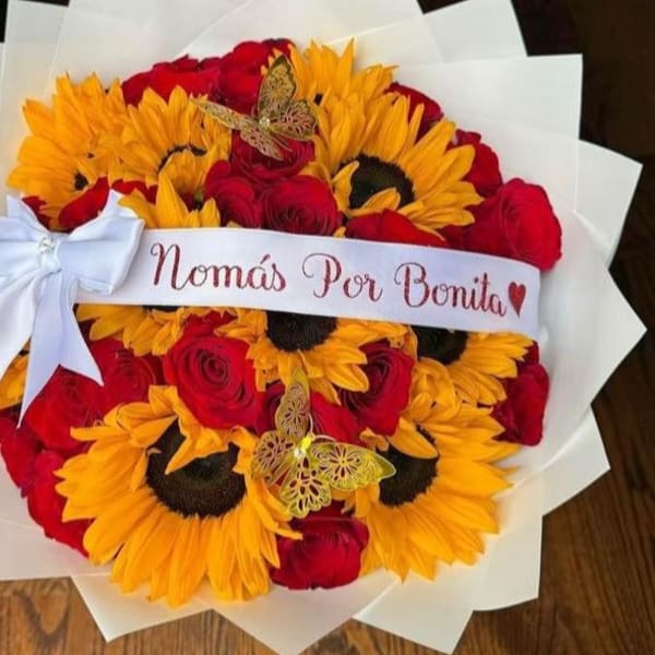 Bouquet of red roses and yellow sunflowers with a white ribbon