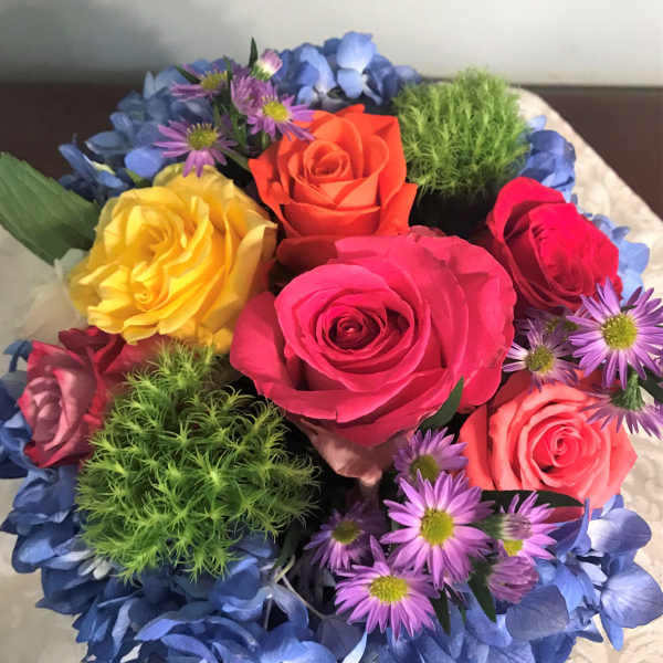 Colorful bouquet of roses and small purple daisies
