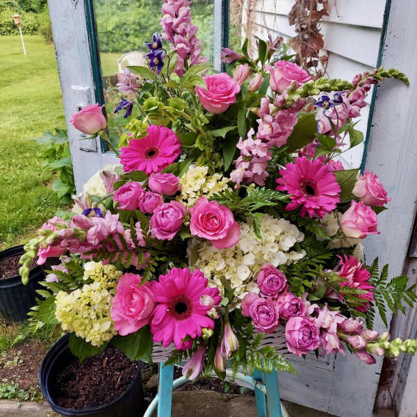 Pink and white mixed flower arrangement with roses and gerbera daisies
