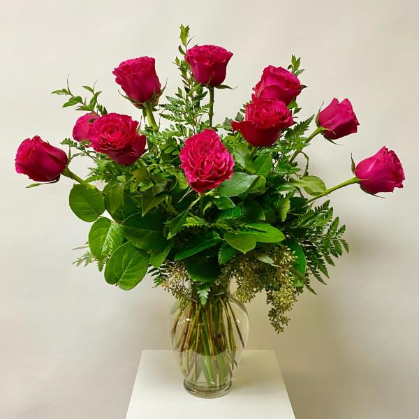 Pink roses arranged in a clear glass vase