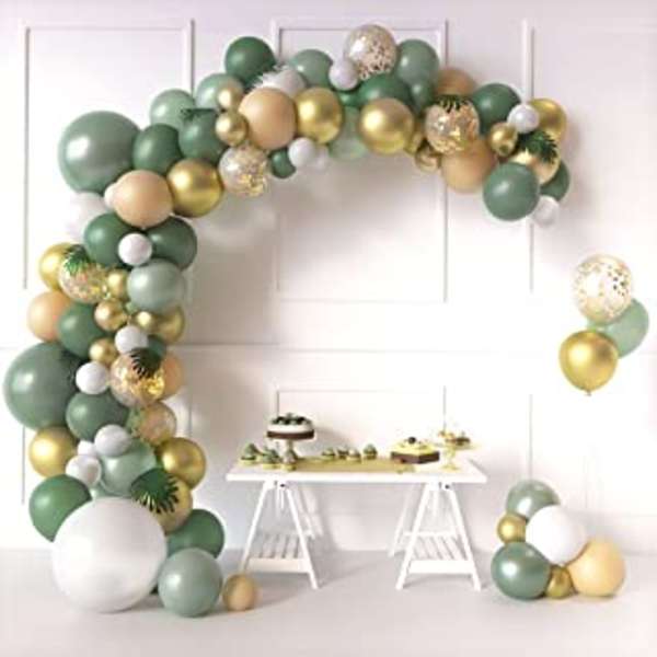 Green, gold, and white balloon arch with a small dessert table