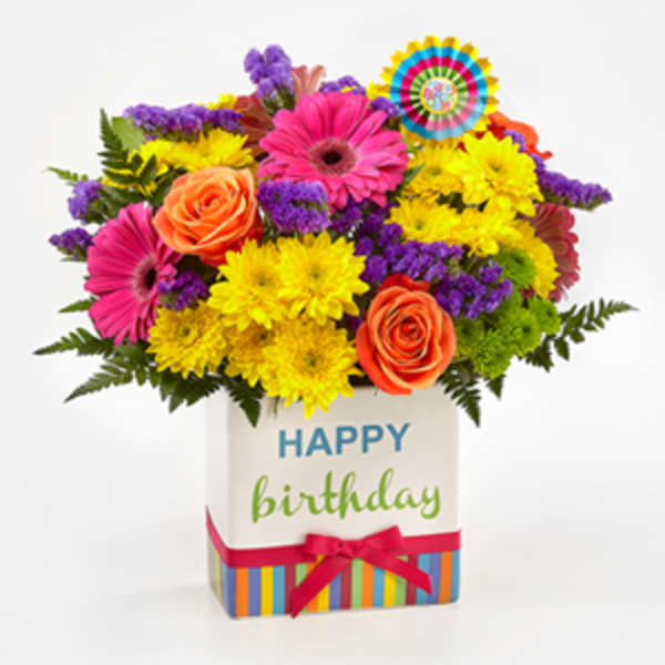 Bright mixed bouquet in a birthday gift box with roses and daisies