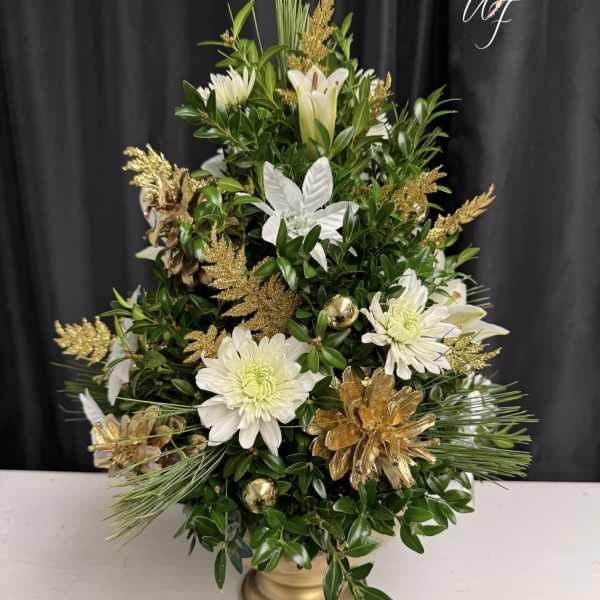 White flowers and gold accents in a gold vase