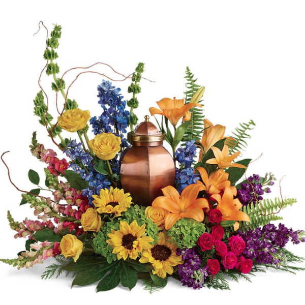 Mixed bouquet with lilies, roses, sunflowers, and a copper urn