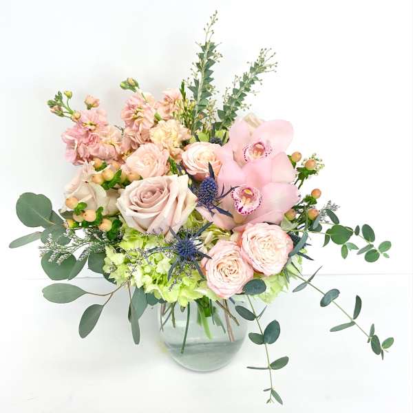 Pink and cream floral arrangement in a glass vase