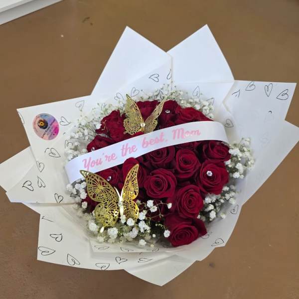 Bouquet of red roses with white baby's breath and butterfly decorations