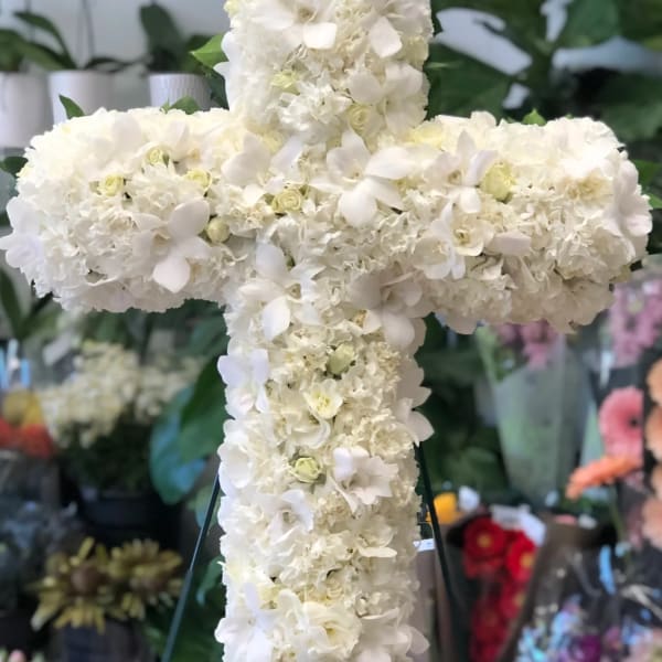 White floral cross on a stand