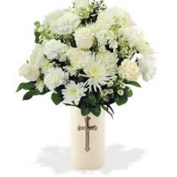 White floral arrangement in a cream vase with a cross emblem