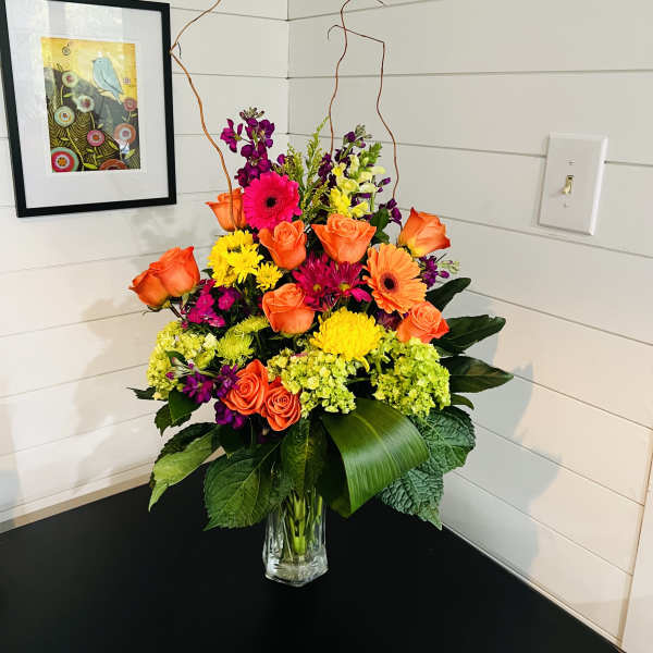 Bright mixed flower arrangement in a clear glass vase