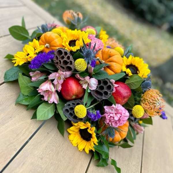 Autumn bouquet with sunflowers, pumpkins, and apples