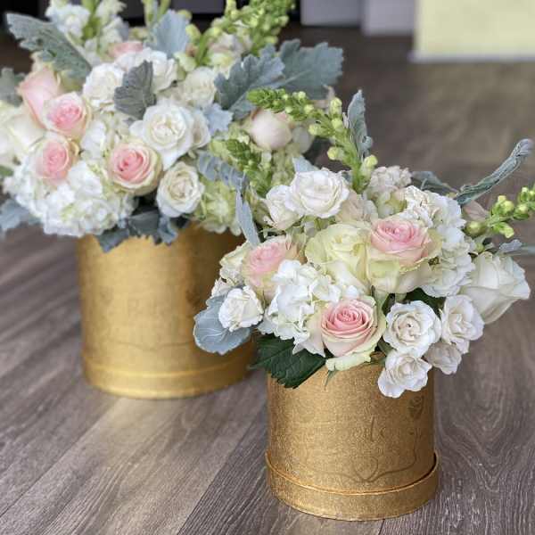 Two pastel rose arrangements in gold boxes