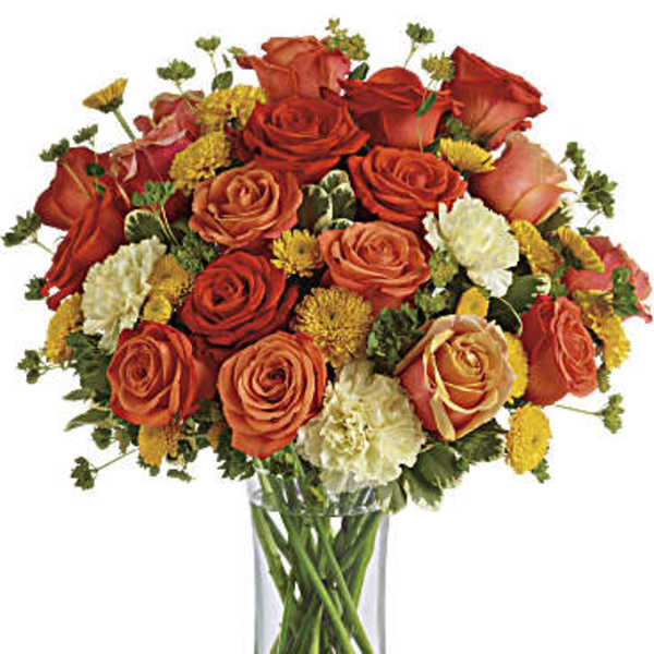 Bouquet of orange and red roses in a clear glass vase