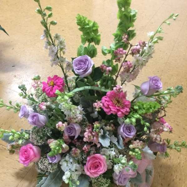 Mixed bouquet with pink and lavender roses and bright pink blooms