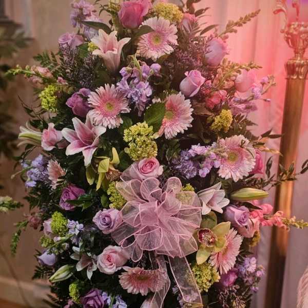 Large pink and lavender floral spray with a sheer ribbon bow