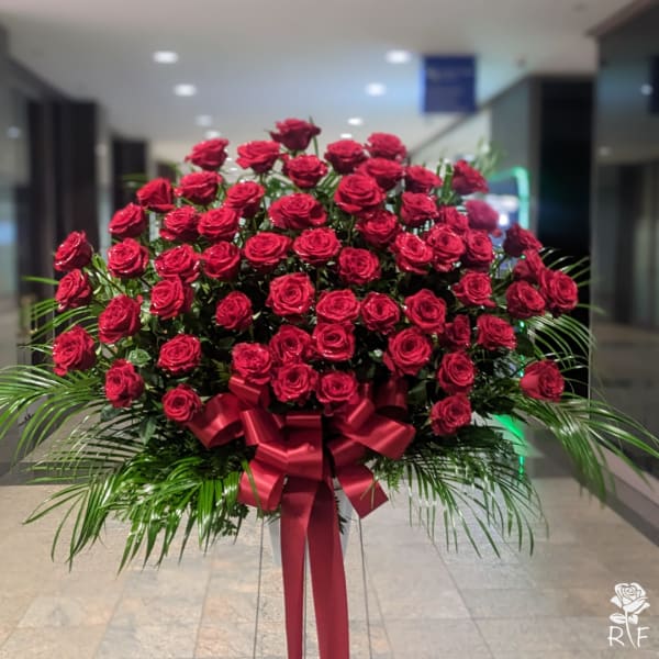 Large bouquet of red roses with a red ribbon bow