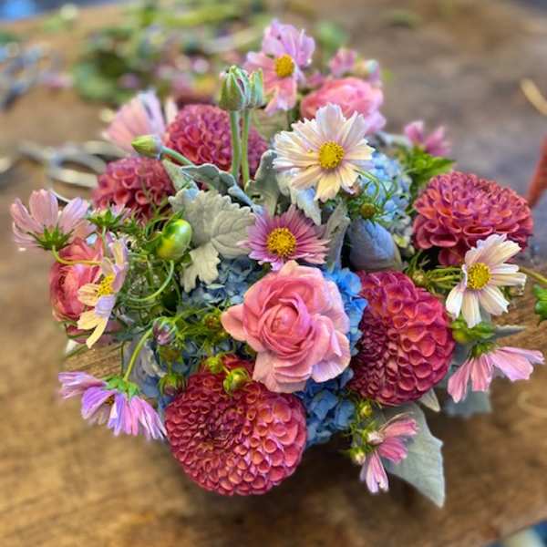 Mixed bouquet of pink, blue, and white flowers