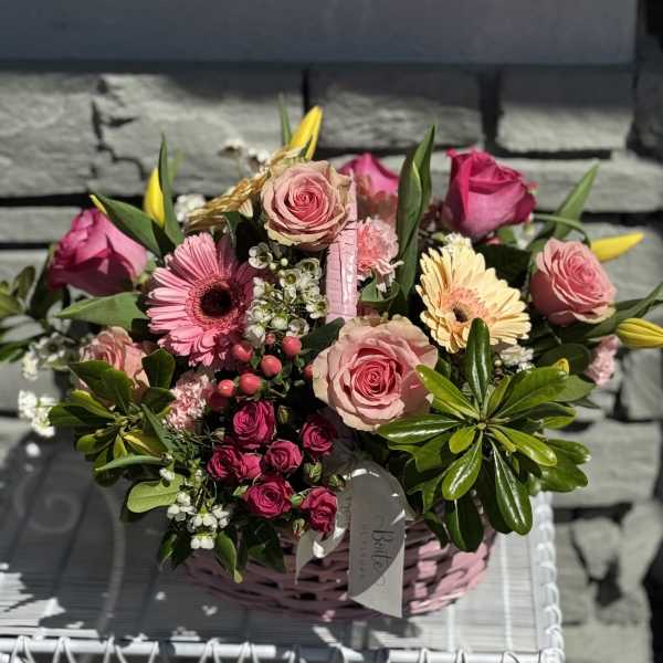 Pink rose and gerbera daisy bouquet in a pink basket