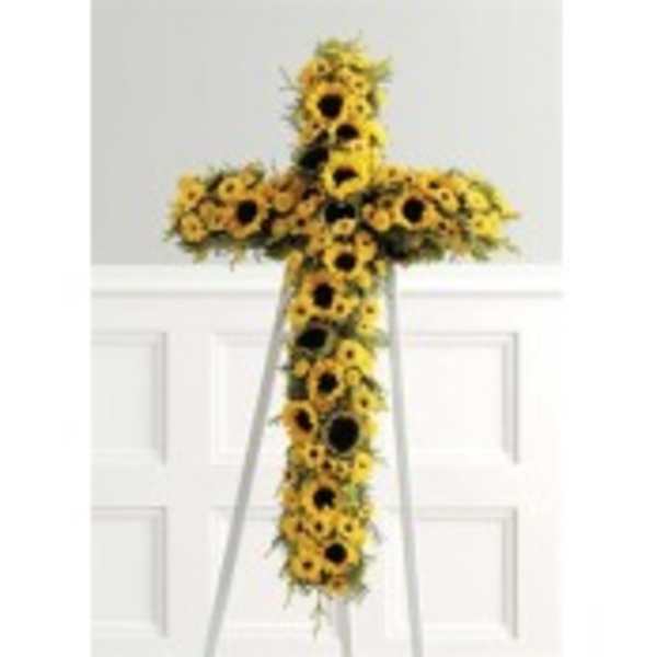 Cross-shaped sunflower funeral spray on a stand