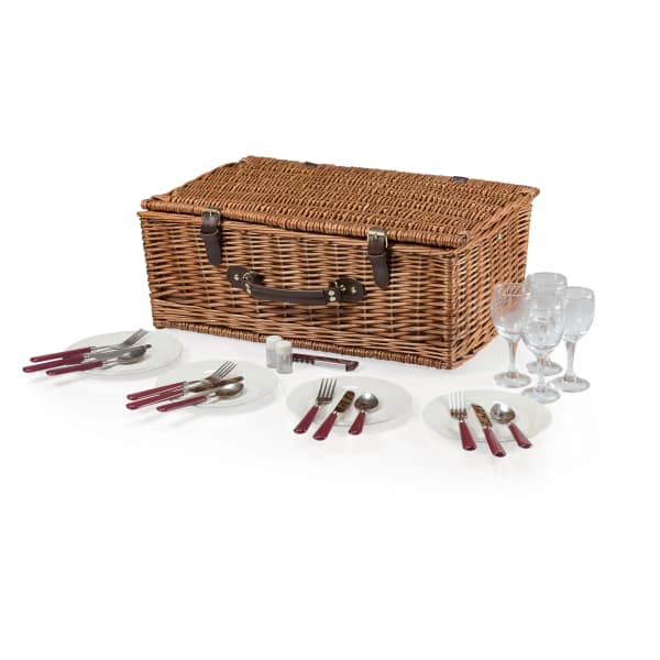 Wicker picnic basket with plates, cutlery, and wine glasses