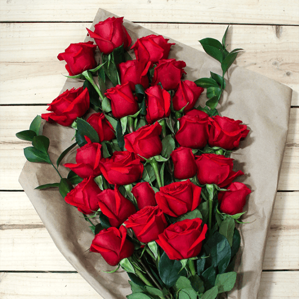Bouquet of red roses wrapped in brown paper