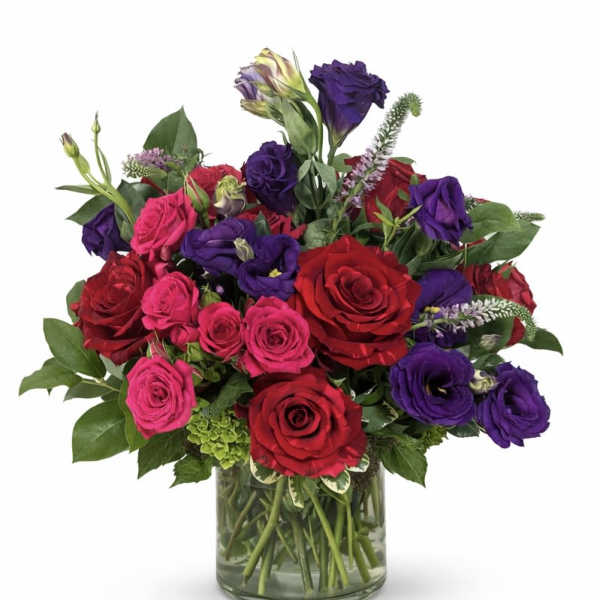Bouquet of red, pink, and purple roses in a glass vase