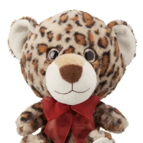 Leopard-print teddy bear with a red ribbon bow