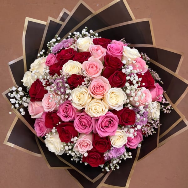 Bouquet of pink, red, and white roses with baby's breath