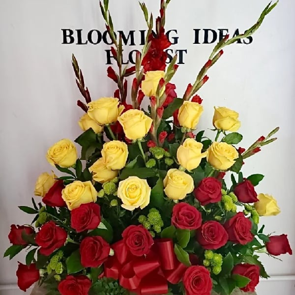 Red and yellow rose arrangement with tall red gladiolus