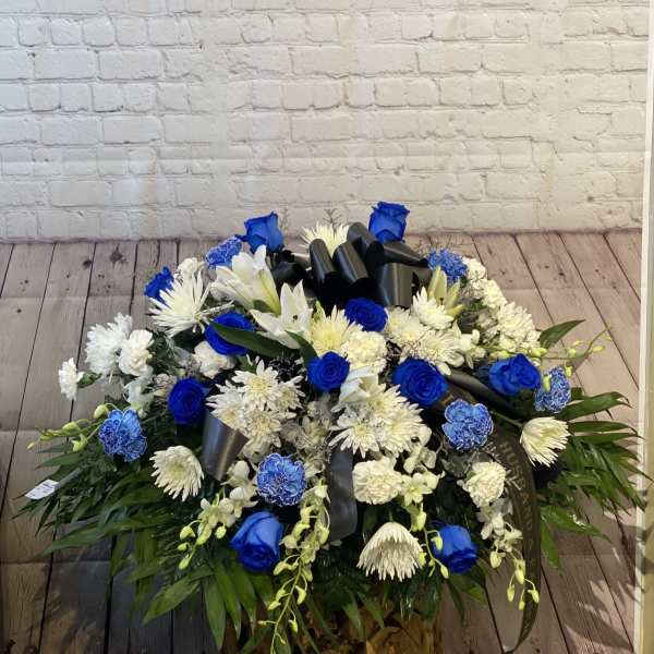 Blue and white floral spray with a black ribbon bow