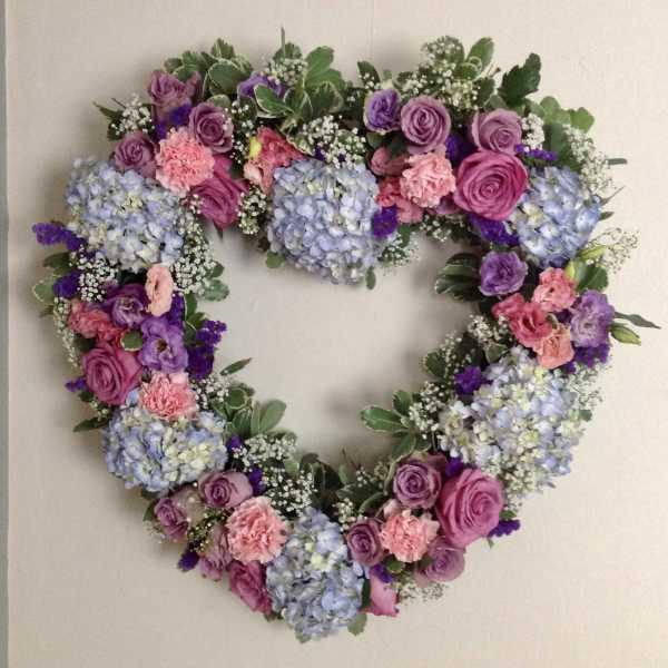 Heart-shaped floral wreath with pink, purple, and blue flowers