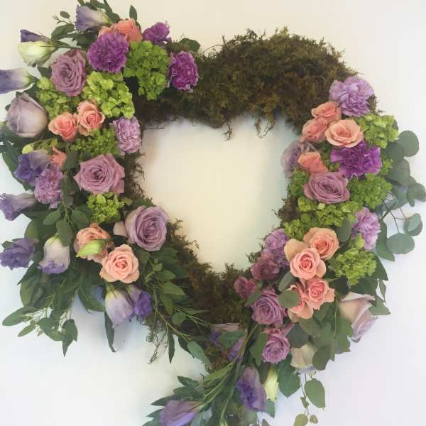 Heart-shaped floral wreath with pink, purple, and green blooms