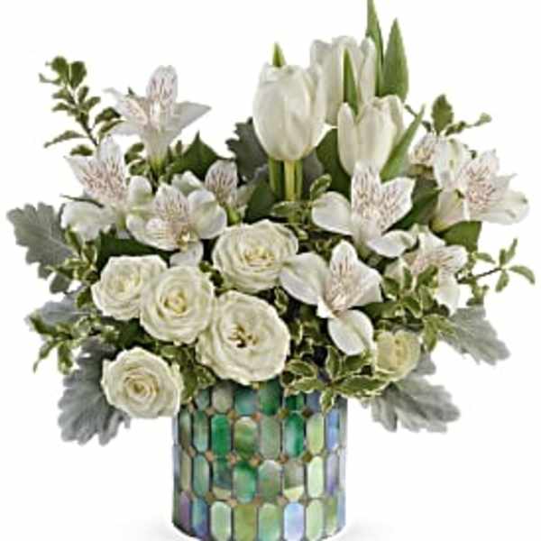 White tulips and roses arranged in a mosaic vase