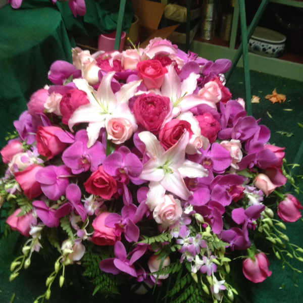 Pink and purple bouquet with white lilies and roses