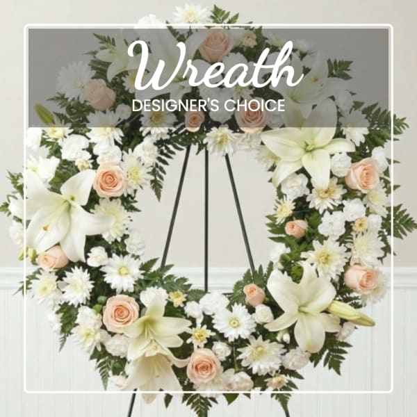 Floral wreath with white lilies, peach roses, and white daisies