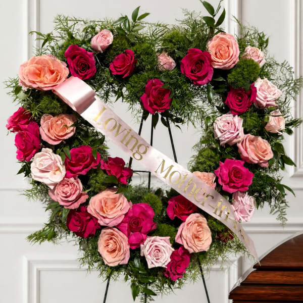 Heart-shaped rose wreath with a satin ribbon reading Loving Mother-in-