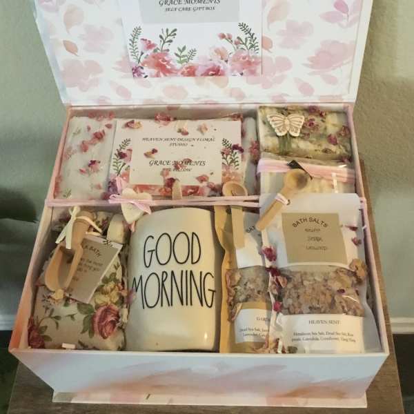 Floral gift box with bath items and a mug labeled Good Morning
