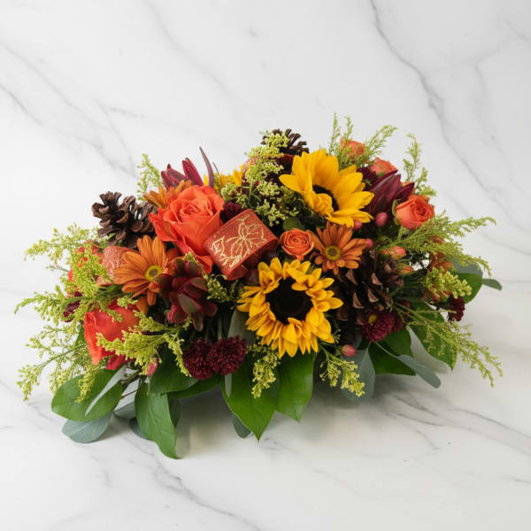 Autumn bouquet with sunflowers, orange roses, and pinecones