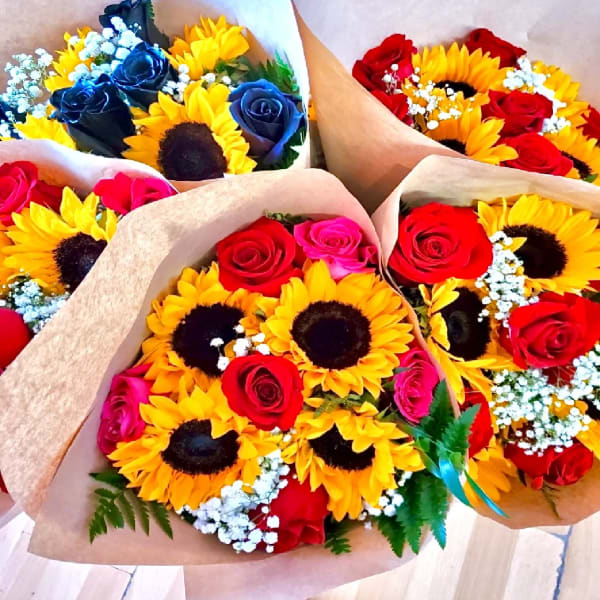 Bouquets of sunflowers and roses wrapped in brown paper