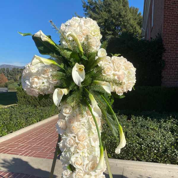 Tall white floral standing spray with roses and calla lilies
