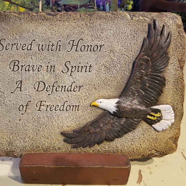 Decorative memorial plaque with an eagle and engraved text
