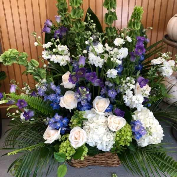 Large basket arrangement of white, purple, and blue flowers