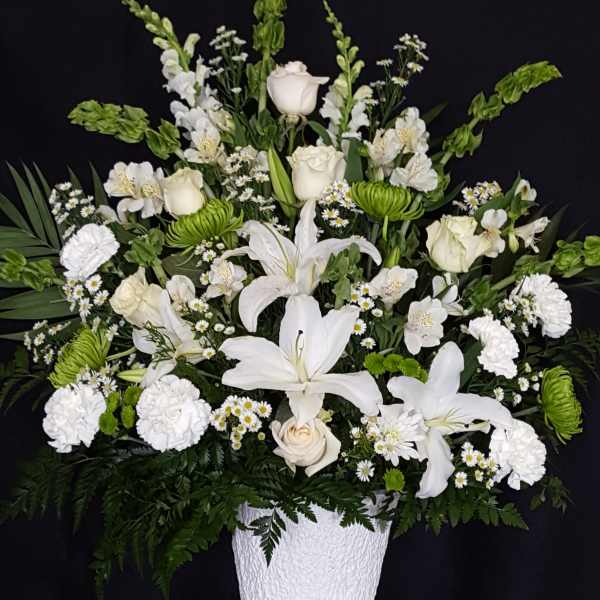 White floral arrangement in a textured white vase