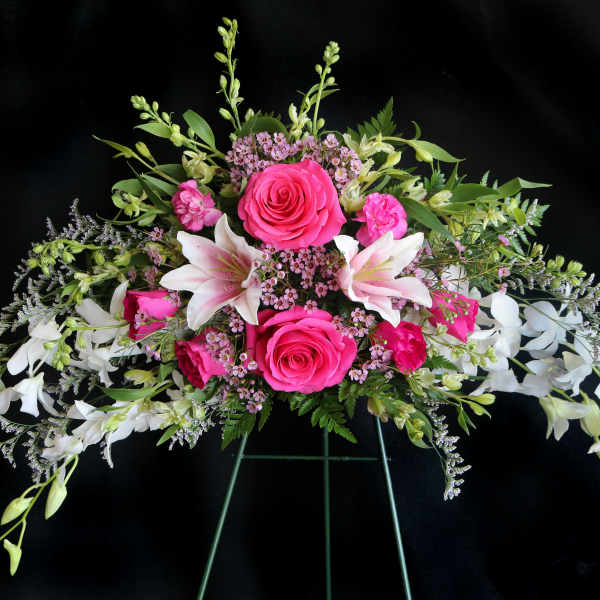 Pink roses and white lilies in a wide floral arrangement