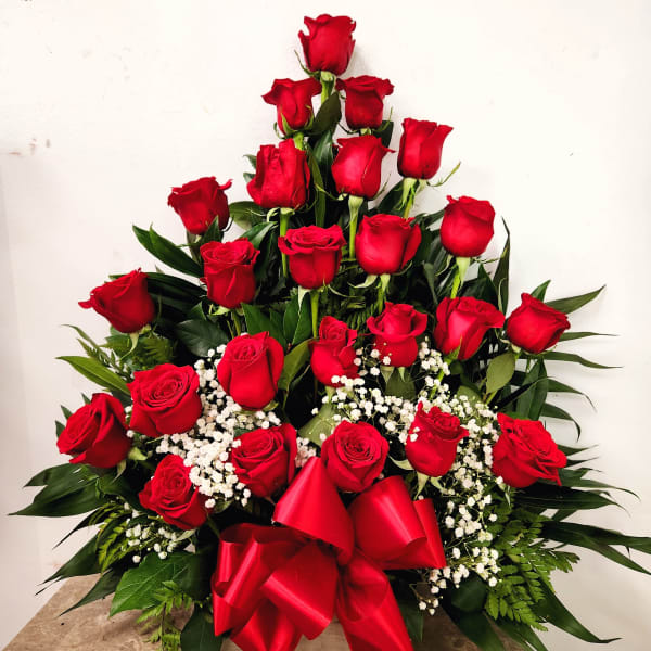 Tiered bouquet of red roses with a red ribbon bow
