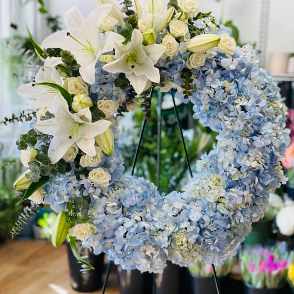 Blue hydrangea wreath with white lilies and cream roses