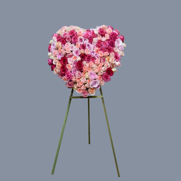 Heart-shaped rose arrangement on an easel